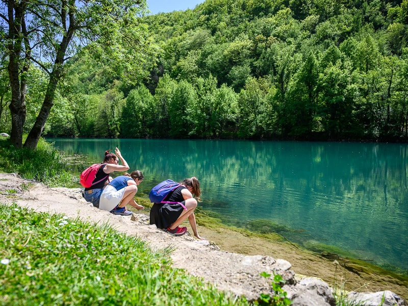 Kinder sitzend vor dem türkisblauen Una Fluss