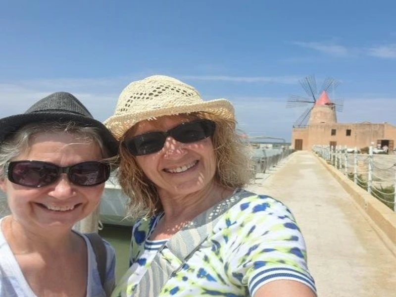 Reisende nahe einem Leuchtturm auf Sizilien in Italien