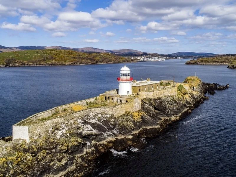 Insel mit einem Leuchtturm aus der Luft fotografiert.