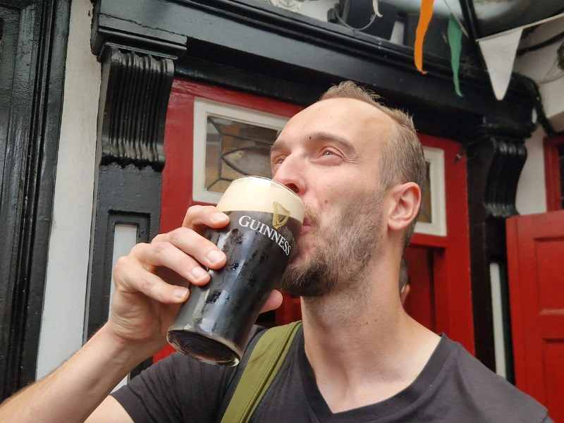 Mann trinkt Guiness in Dublin
