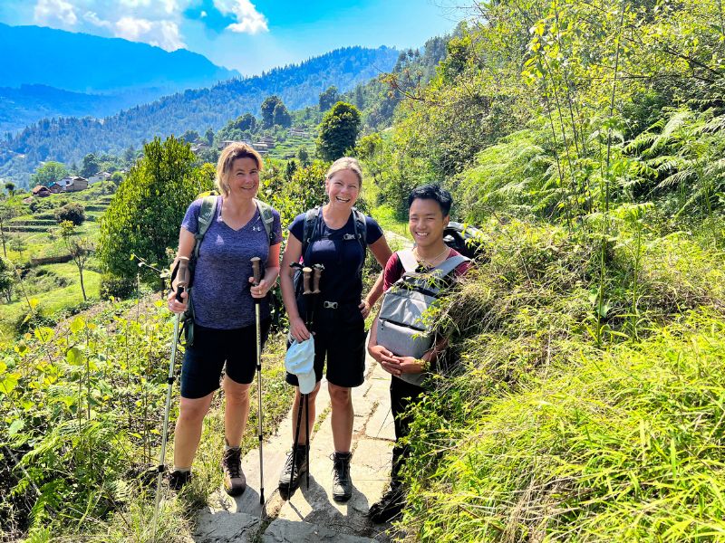 Touristen mit Träger beim Trekking in Nepal