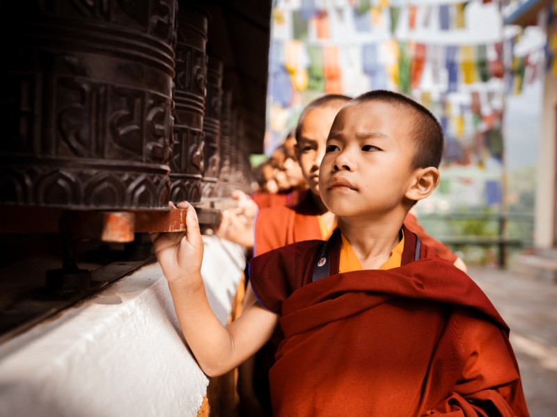 Junge Mönche an Gebetsmühlen im Kloster, Nepal
