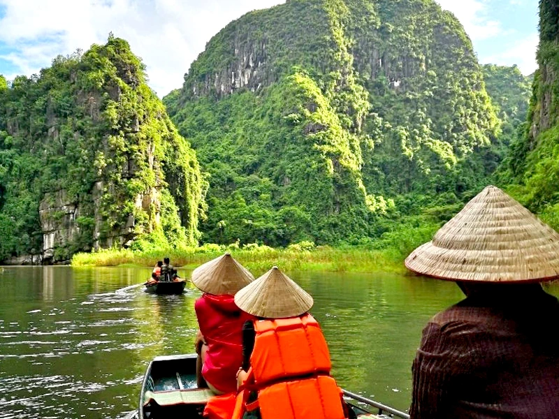 Reisende einem Boot durch die Halongbucht