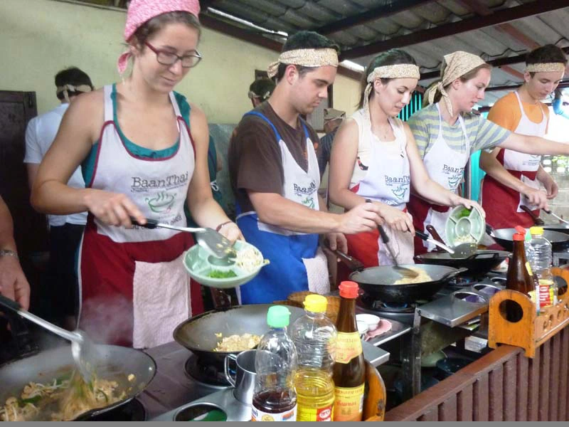 Touristen Kochen beim Kochkurs in Chiang Mai Thailand