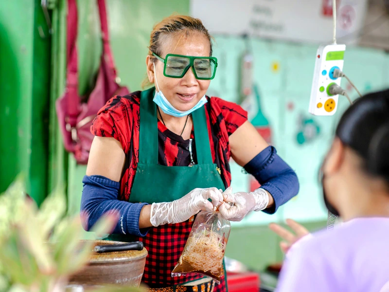 Thailändische Frau verkauft Streetfood