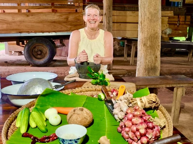 Frau beim Kochen in einem lokalen Haus in Thailand