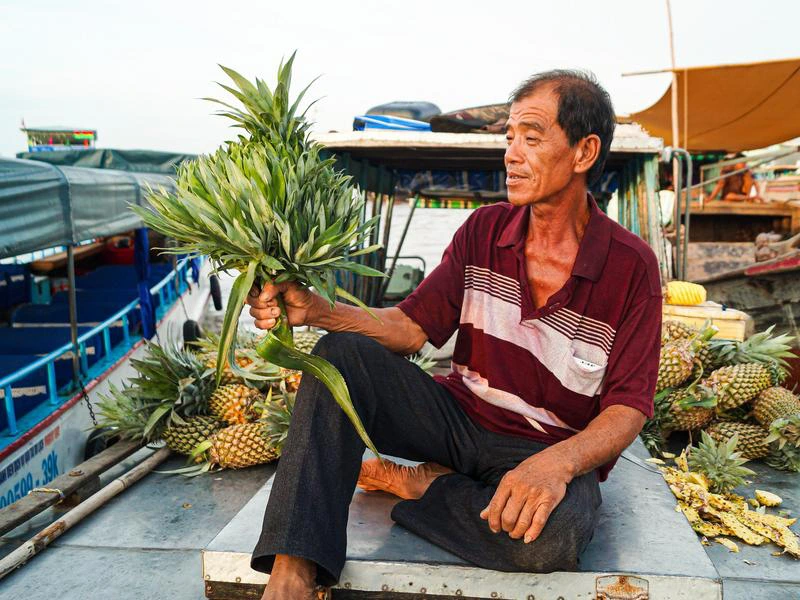 Verkäufer auf einem Boot im Mekong Delta Vietnam