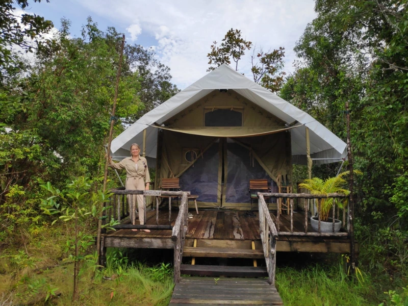 Frau auf der Veranda eines Zeltes im Cardamom Tented Camp in Kambodscha
