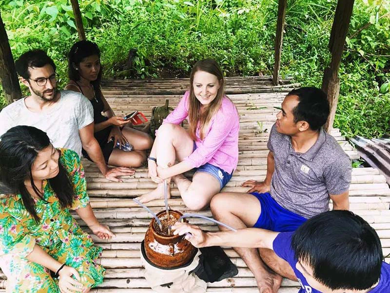Touristen bei einer Pause in den Reisfeldern in Laos