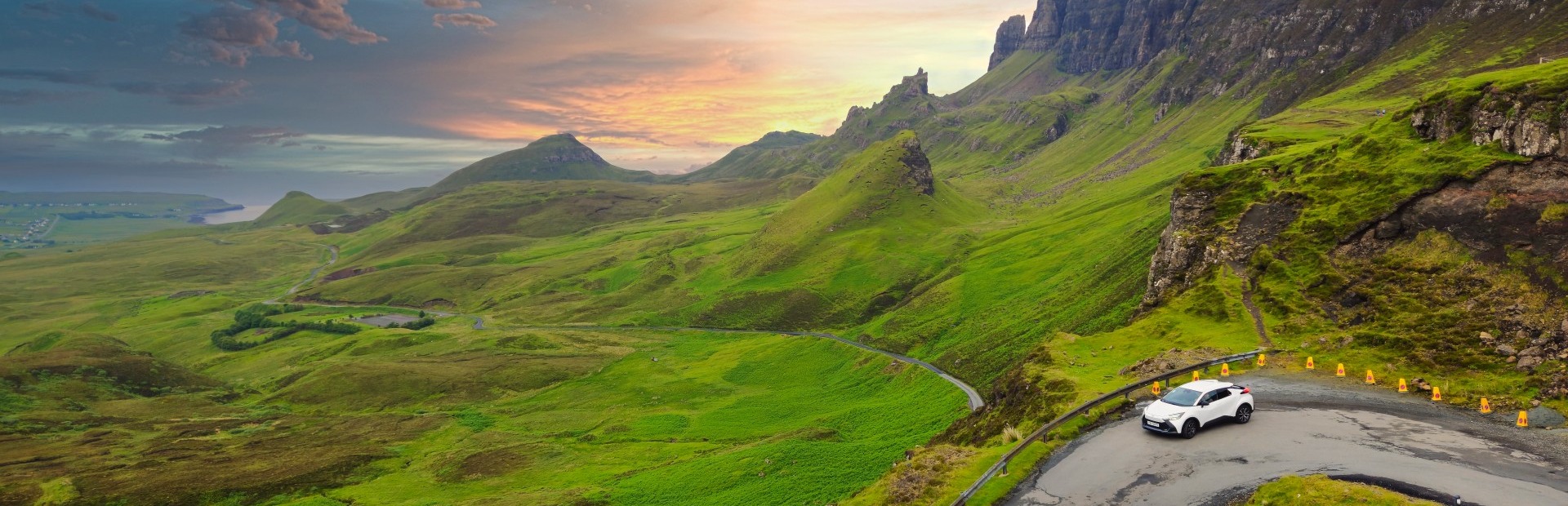 Auto auf Straße umgeben von grüner Landschaft