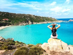 Frau blickt aufs Meer in Sardinien, Italien