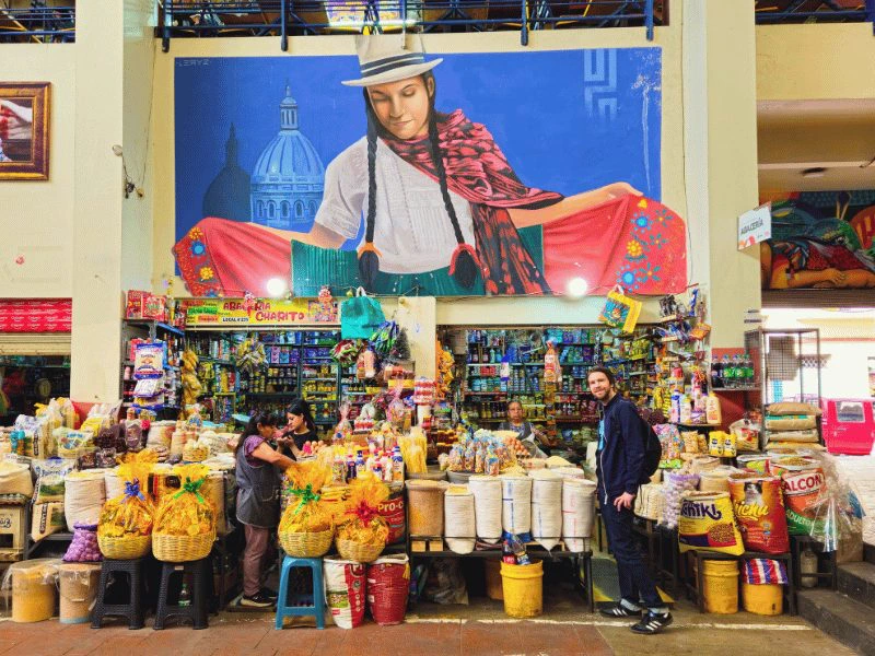 Marktstände mit großem Wandbild einer indigenen Frau dahinter