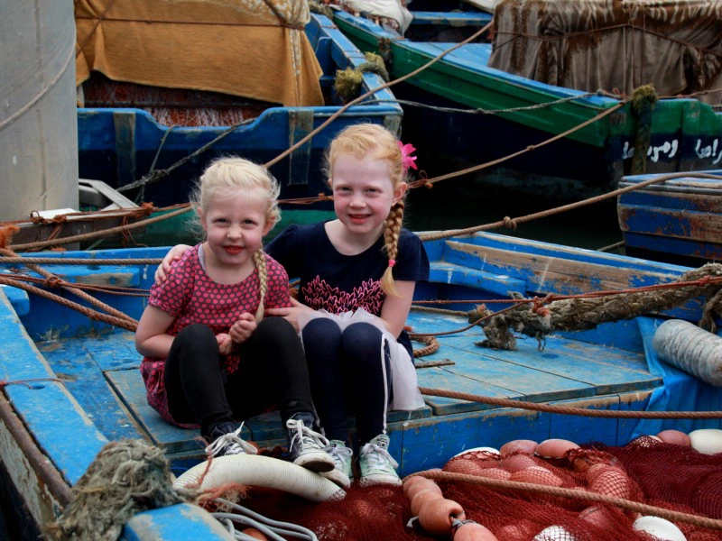 Kinder sitzend am Hafen bei Tanger, Marokko